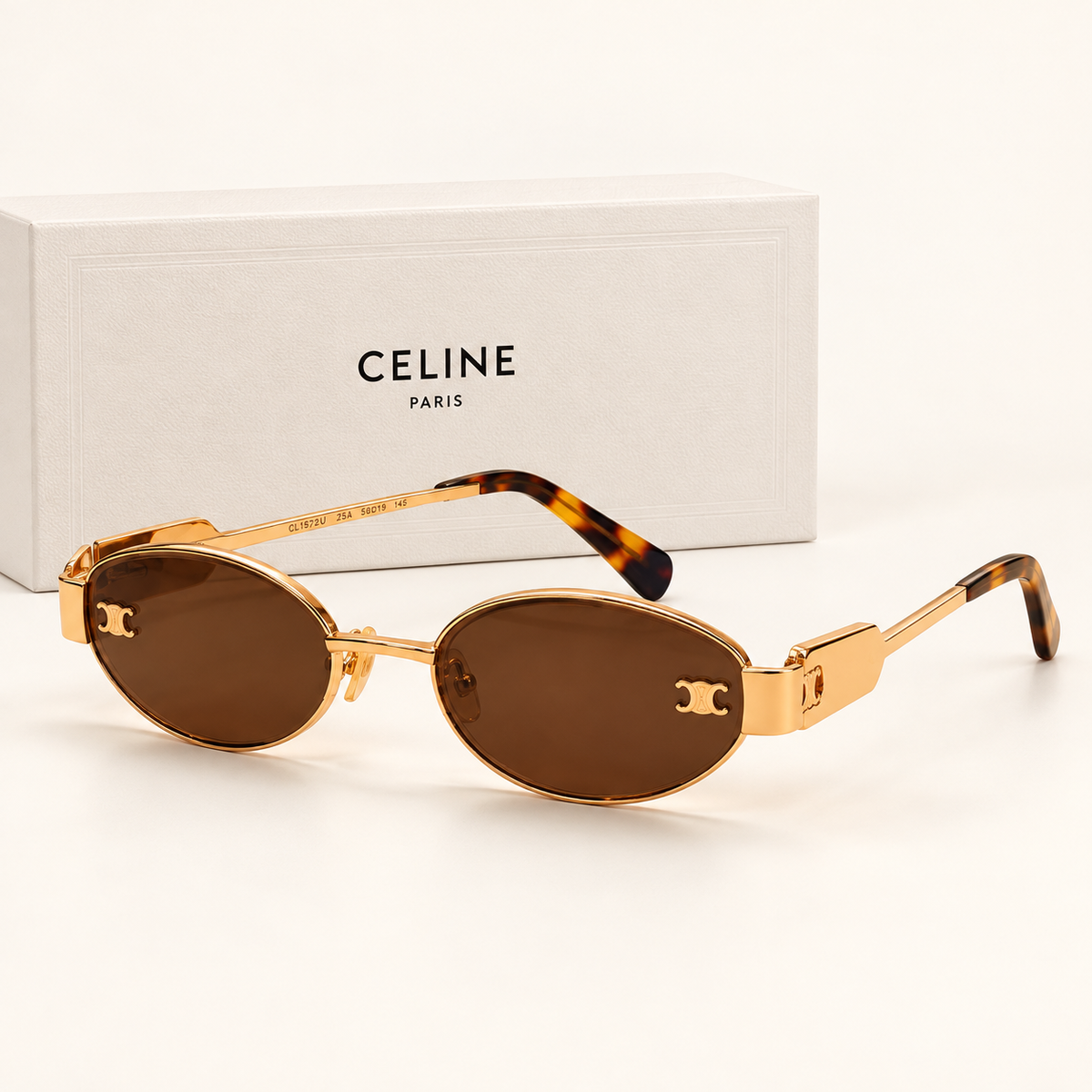 CLN — Gold Brown Oval Sunglasses – Model 1 — front-left view with brand box